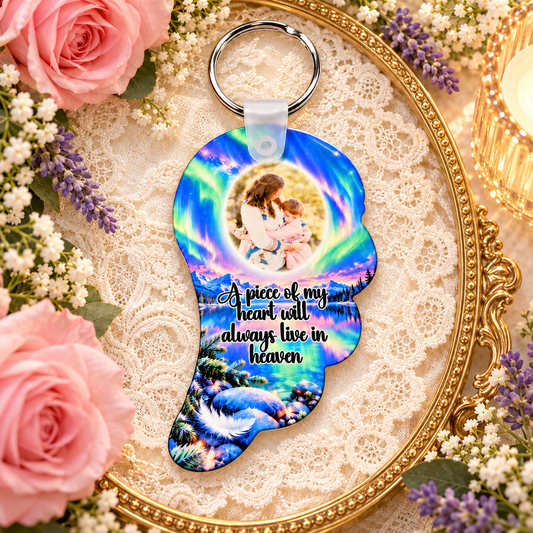 Northern lights angel wing memorial photo keyring displayed on a gold tray with lace, flowers and candlelight