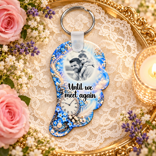 Blue and silver memorial angel wing photo keyring displayed on a gold tray with lace, pink roses and candlelight
