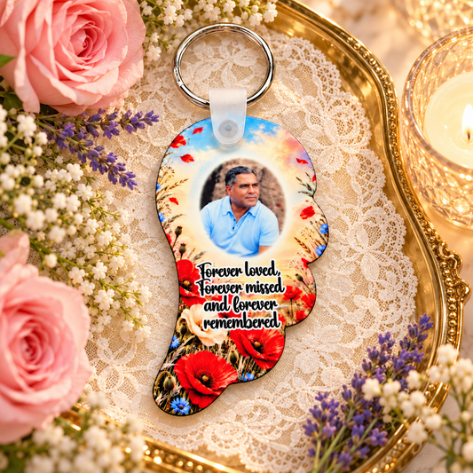 Poppy remembrance angel wing photo keyring displayed on a gold tray with lace, pink roses and candlelight