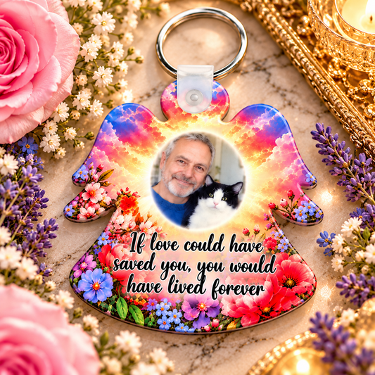 Memorial angel photo keyring with colourful floral design displayed beside pink roses and lavender