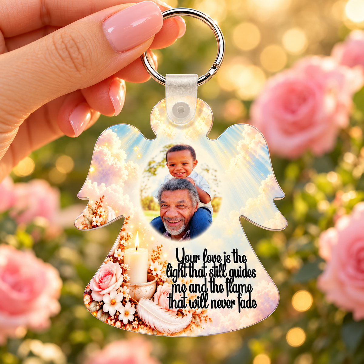 Memorial candle angel photo keyring held in hand against pink roses and warm fairy lights, featuring heavenly clouds and a personalised photograph