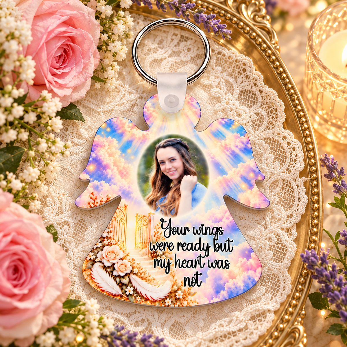 Personalised Heaven's Gates angel remembrance keyring displayed on gold tray with lace, pink roses, lavender and candlelight