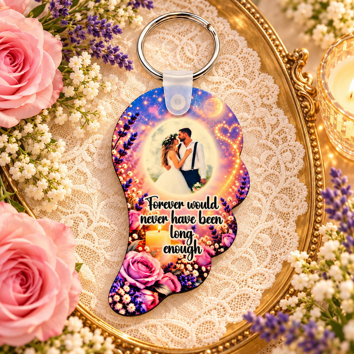 Personalised angel wing remembrance keyring on a gold tray with lace, pink roses and candlelight
