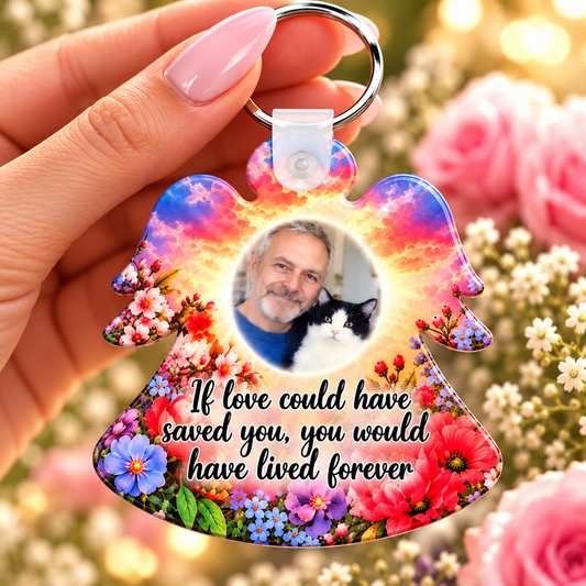 Floral angel memorial photo keyring with pink and orange sunset colours held in hand