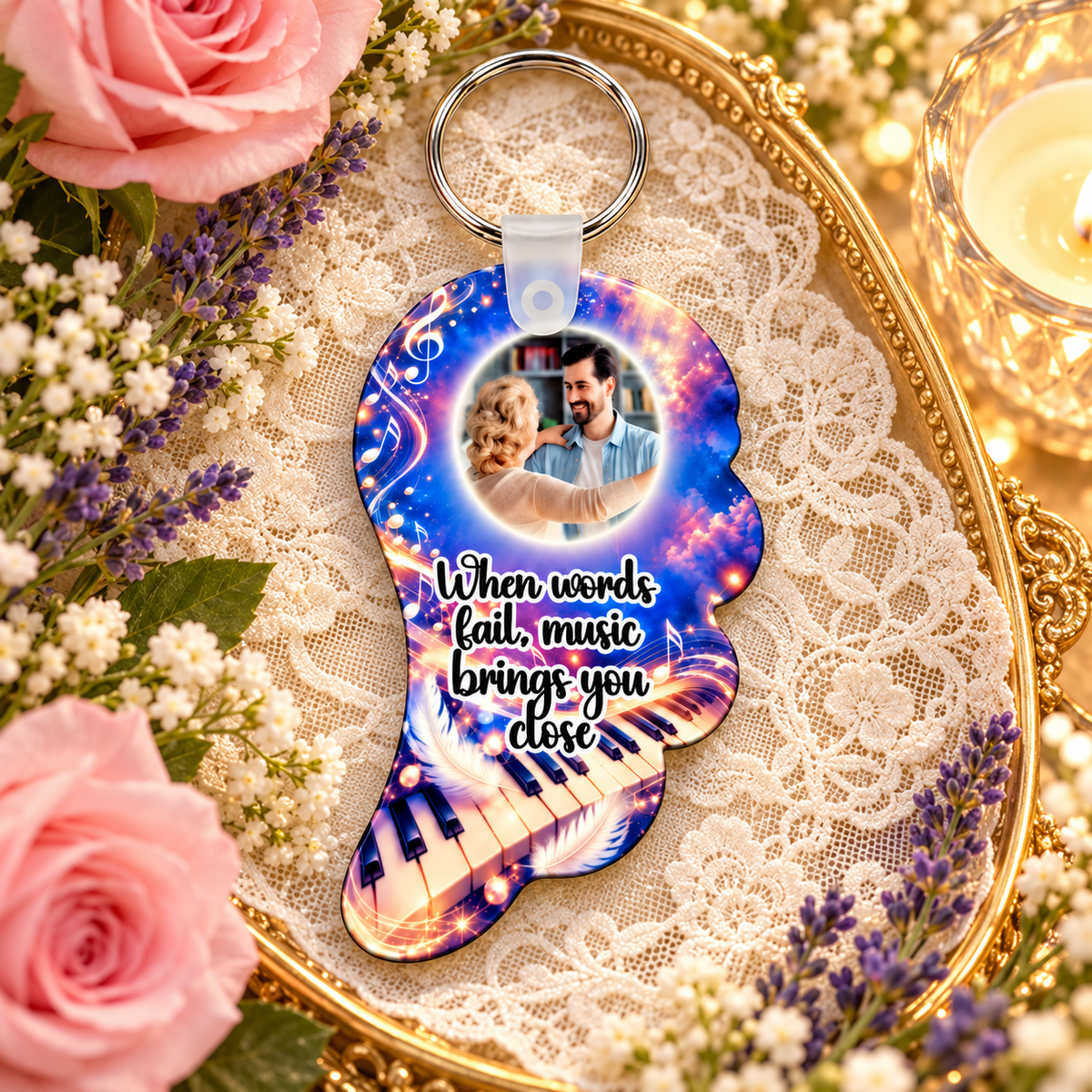 Music memorial photo angel wing keyring displayed on a gold tray with lace, pink roses, lavender and candlelight