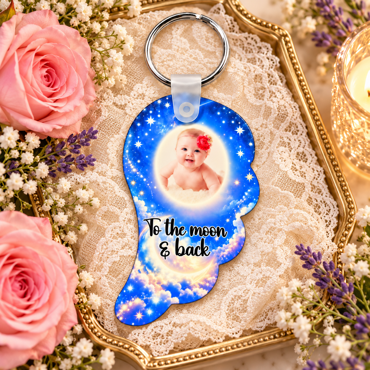 Blue moon and stars angel wing memorial keyring displayed on a gold tray with lace, flowers and candlelight